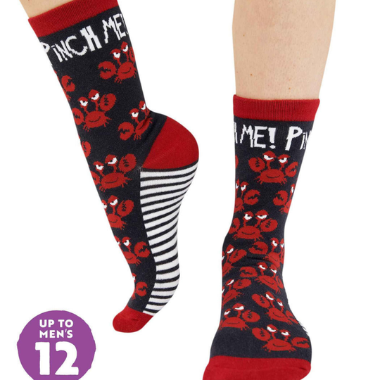 Pair of socks with red and black designs and 'Pinch Me!' text on a white background