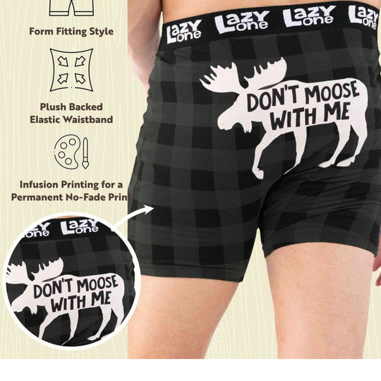 Black boxer briefs with 'Don't Moose With Me' graphic and brand name on a beige background.
