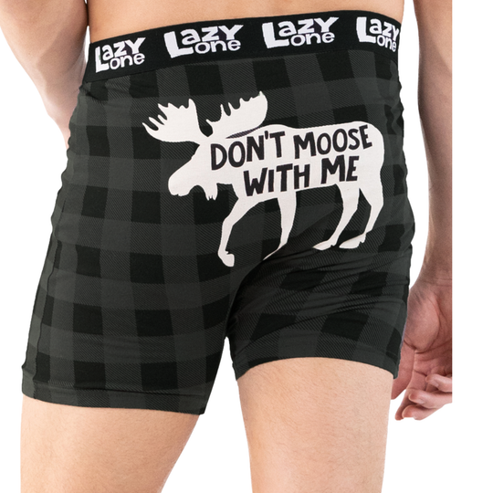 Black boxer briefs with moose graphic and text 'Don't Moose With Me' on a checkered pattern, brand 'Lazy One' visible.