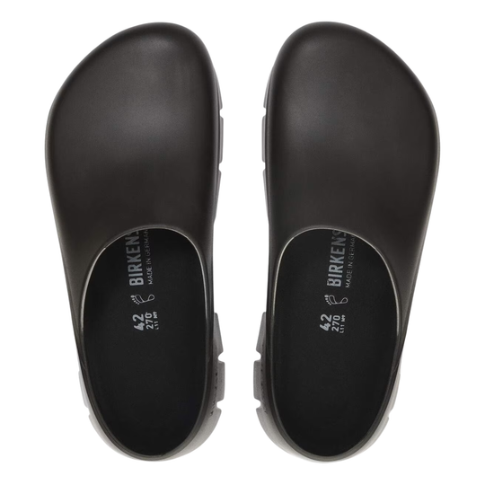 Black clogs with 'Birkenstock' branding on a white background