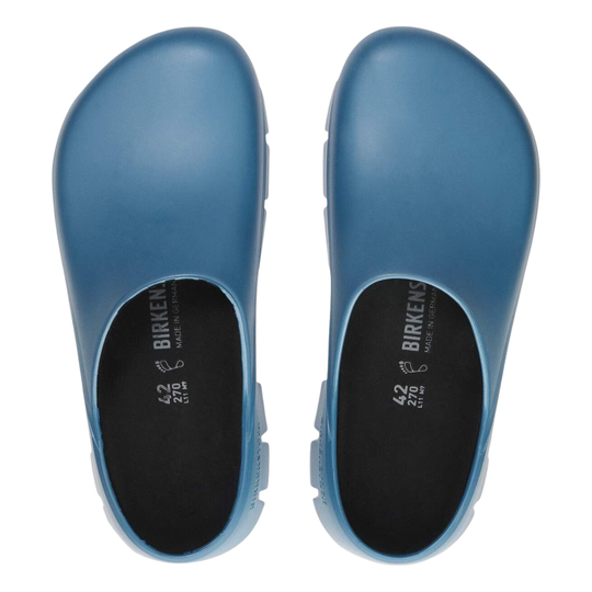 Blue clogs with black soles on a white background