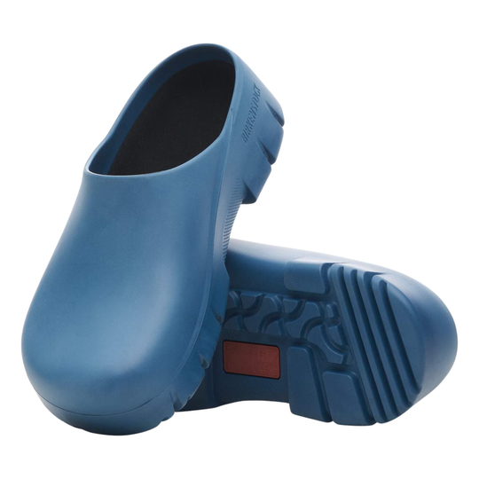 Pair of blue rubber clogs on a white background