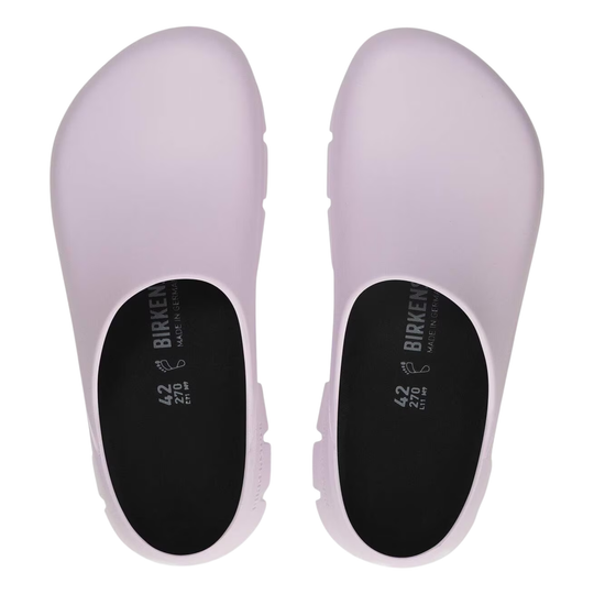 Pair of light purple clogs with black soles on a white background