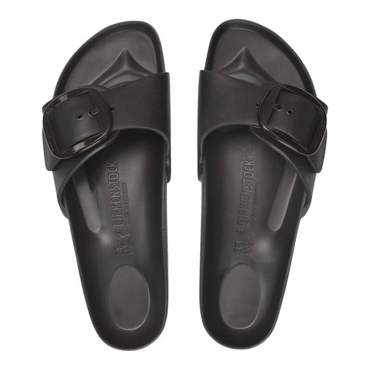 Pair of black sandals with a buckle on a white background
