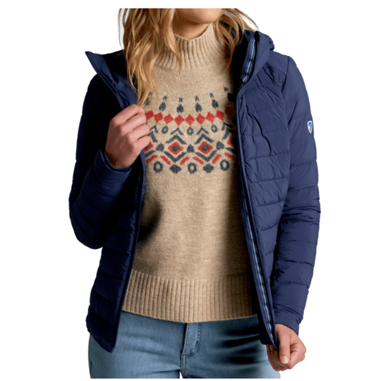 Person wearing a navy blue puffer jacket over a beige sweater with a pattern.