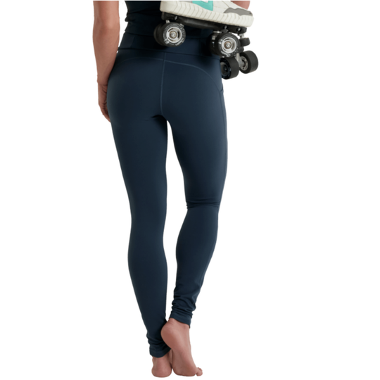 Person wearing navy leggings with roller skates on a white background