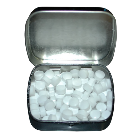 Small open container filled with white mints on a white background