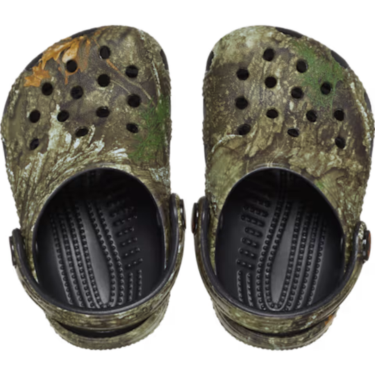 Camouflage-patterned clogs with black soles on a white background