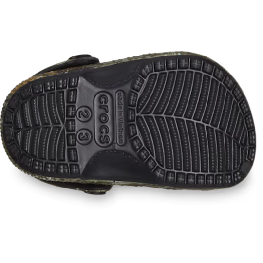 Black Crocs sandal sole on a white background