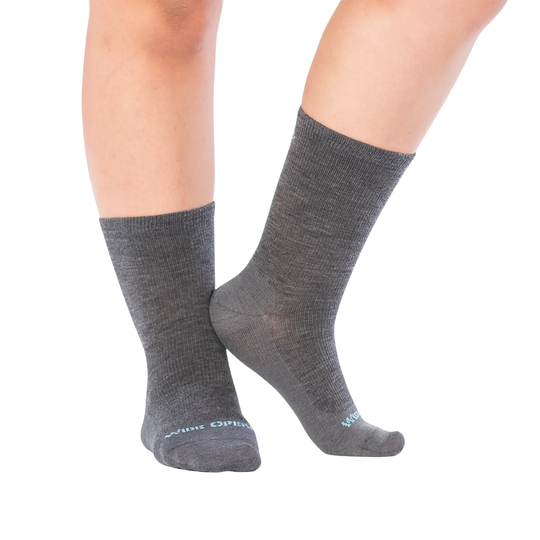 Person wearing gray socks on a white background
