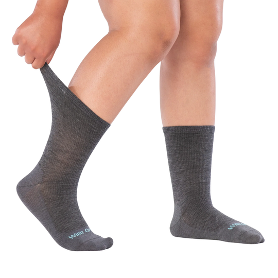 Person wearing gray socks on a white background
