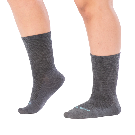 Gray socks worn by a person on a white background