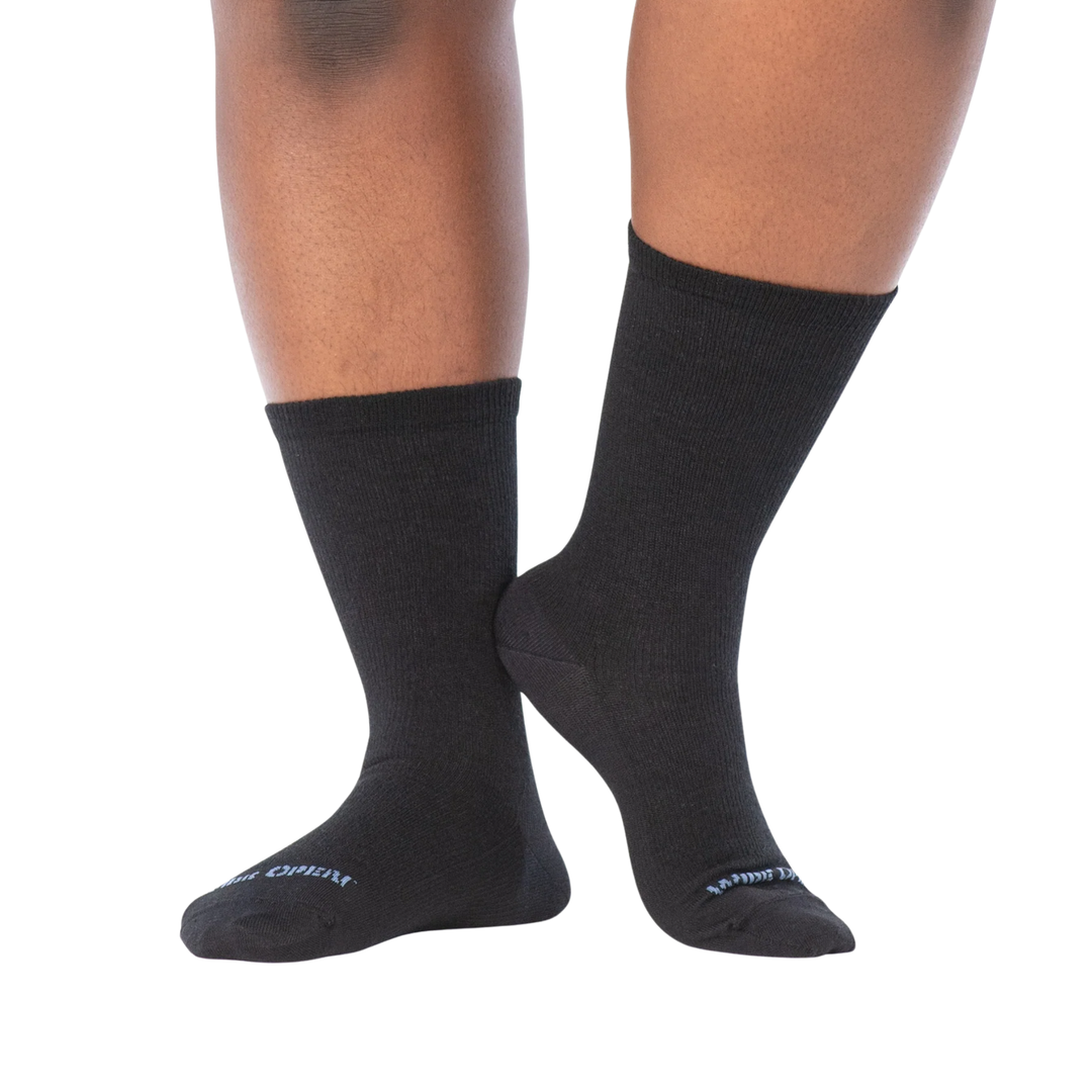 Black socks worn by a person on a white background