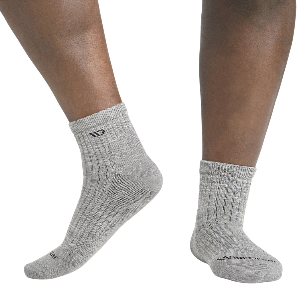 Gray socks worn by a person on a white background
