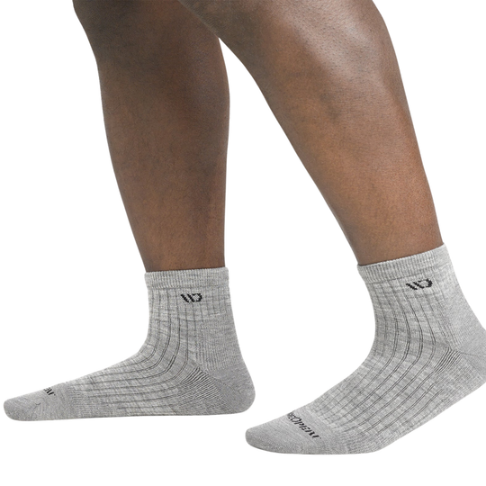 Gray socks worn by a person on a white background