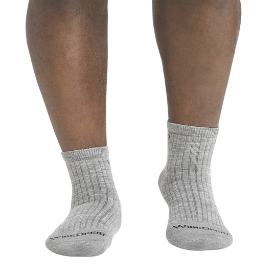 Gray socks worn by a person on a white background