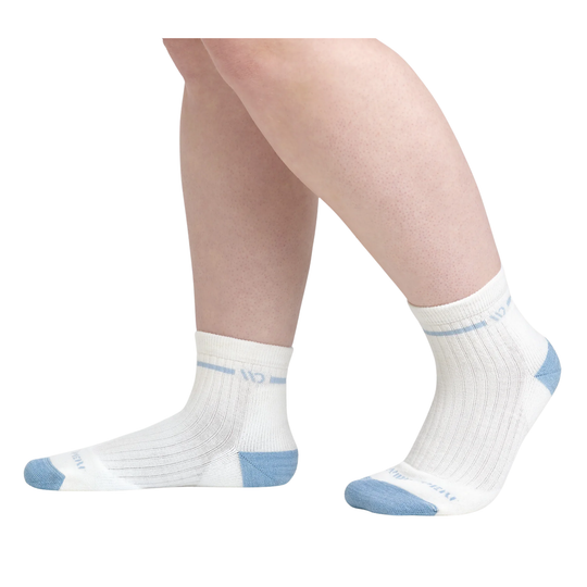 White socks with blue accents worn by a person on a white background