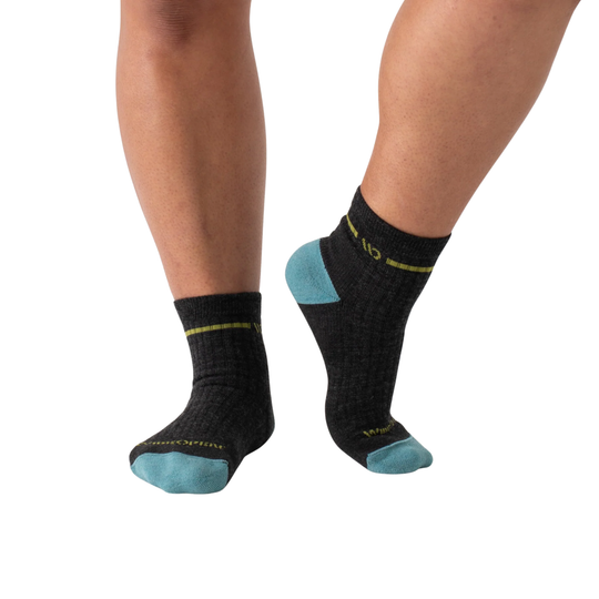 grey socks with blue toes and heels worn by a person on a white background