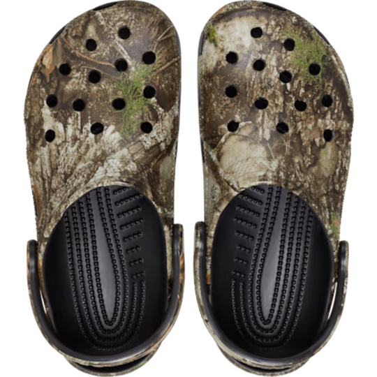 Pair of camouflage clogs with black soles on a white background