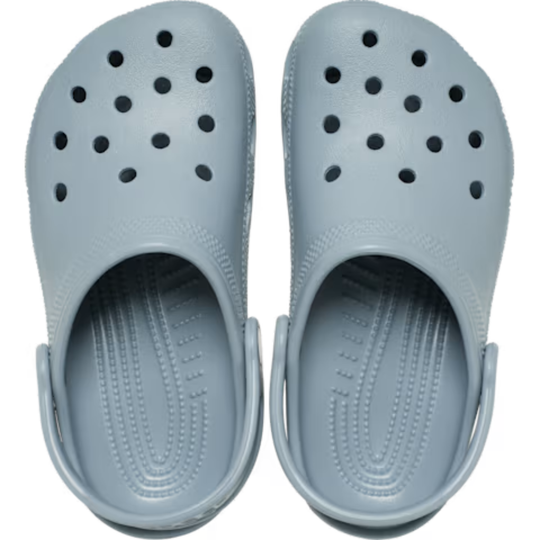 Pair of light blue clogs on a white background