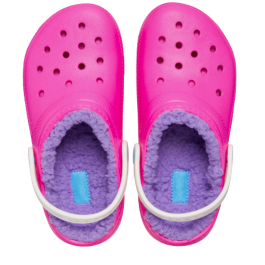 Pink clogs with purple lining and white straps on a white background