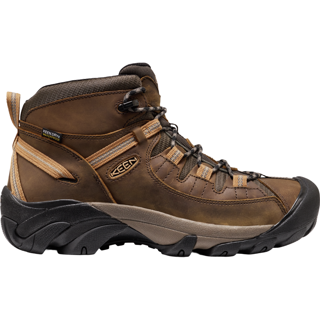 Brown hiking boot with black sole on a white background