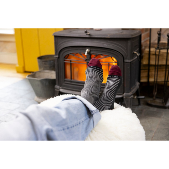 Gray and red striped socks in front of the fireplace