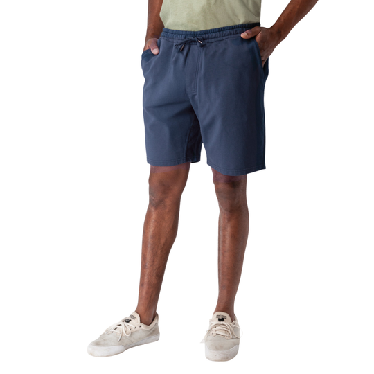 Person wearing blue shorts on a white background