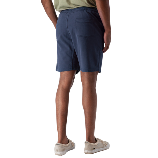Person wearing navy shorts on a white background