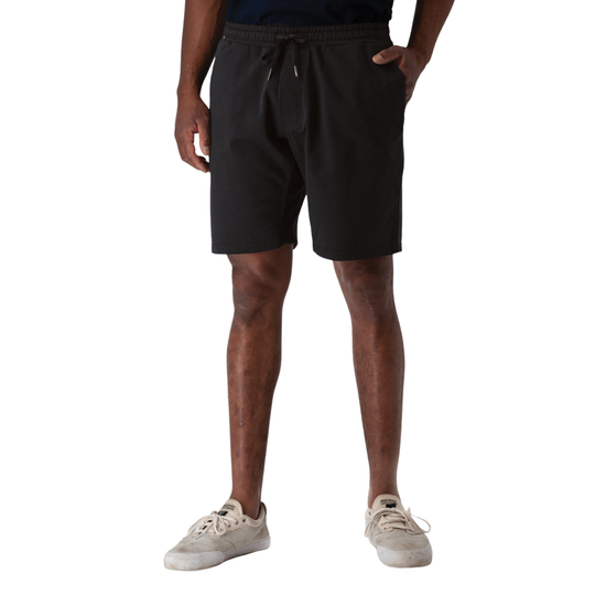 Person wearing black shorts on a white background