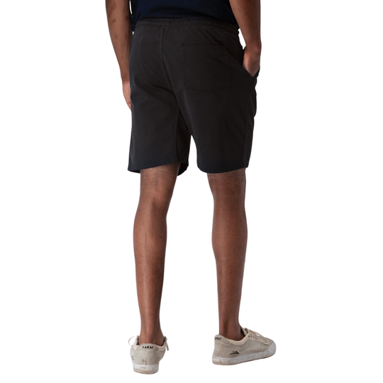 Person wearing black shorts on a white background