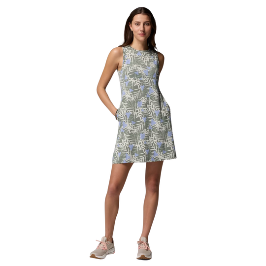 Woman wearing a sleeveless floral dress on a white background