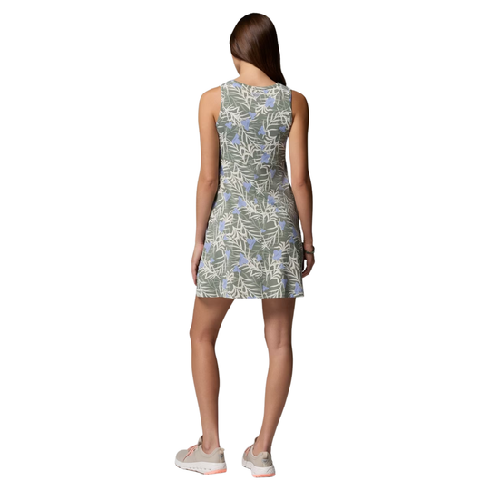 Woman wearing a sleeveless floral dress on a white background