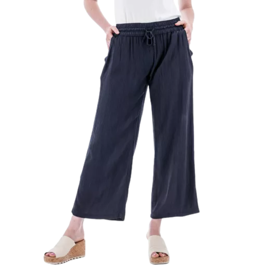 Navy wide-leg pants worn by a person on a white background