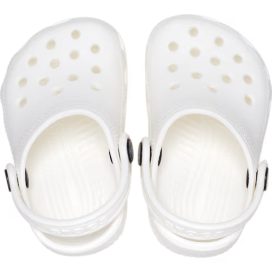 White clogs with gold polka dots on a white background