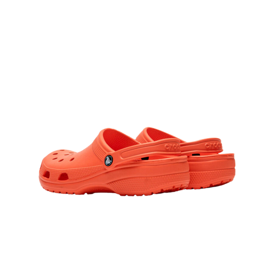 Orange clogs with a visible brand logo on a white background