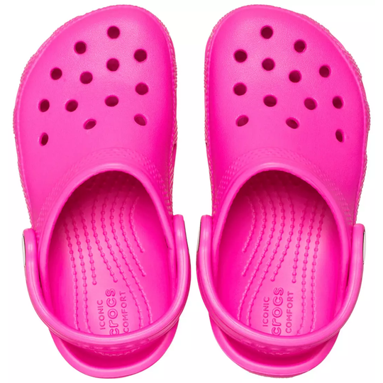 Pair of bright pink clogs on a white background