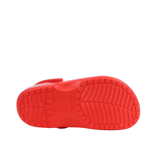 Red sandal with textured sole on a white background