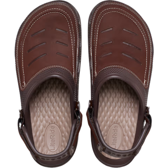 Pair of brown sandals with a white sole on a white background