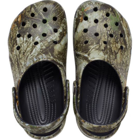 Pair of camouflage clogs with black soles on a white background