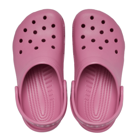 Pair of pink clogs on a white background