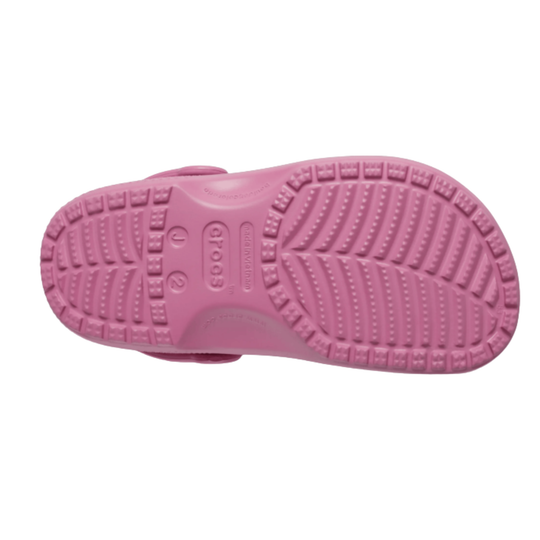 Pink sandal with textured sole on a white background
