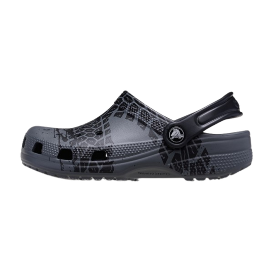Black clog shoe with patterned sole on a white background