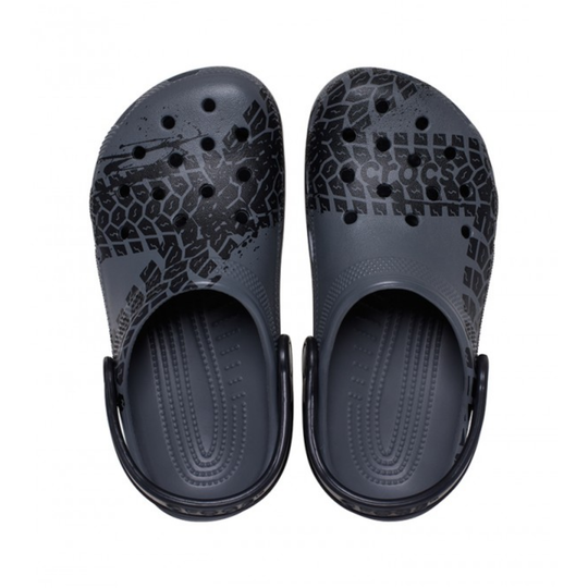 Pair of dark gray clogs with patterned sole on a white background