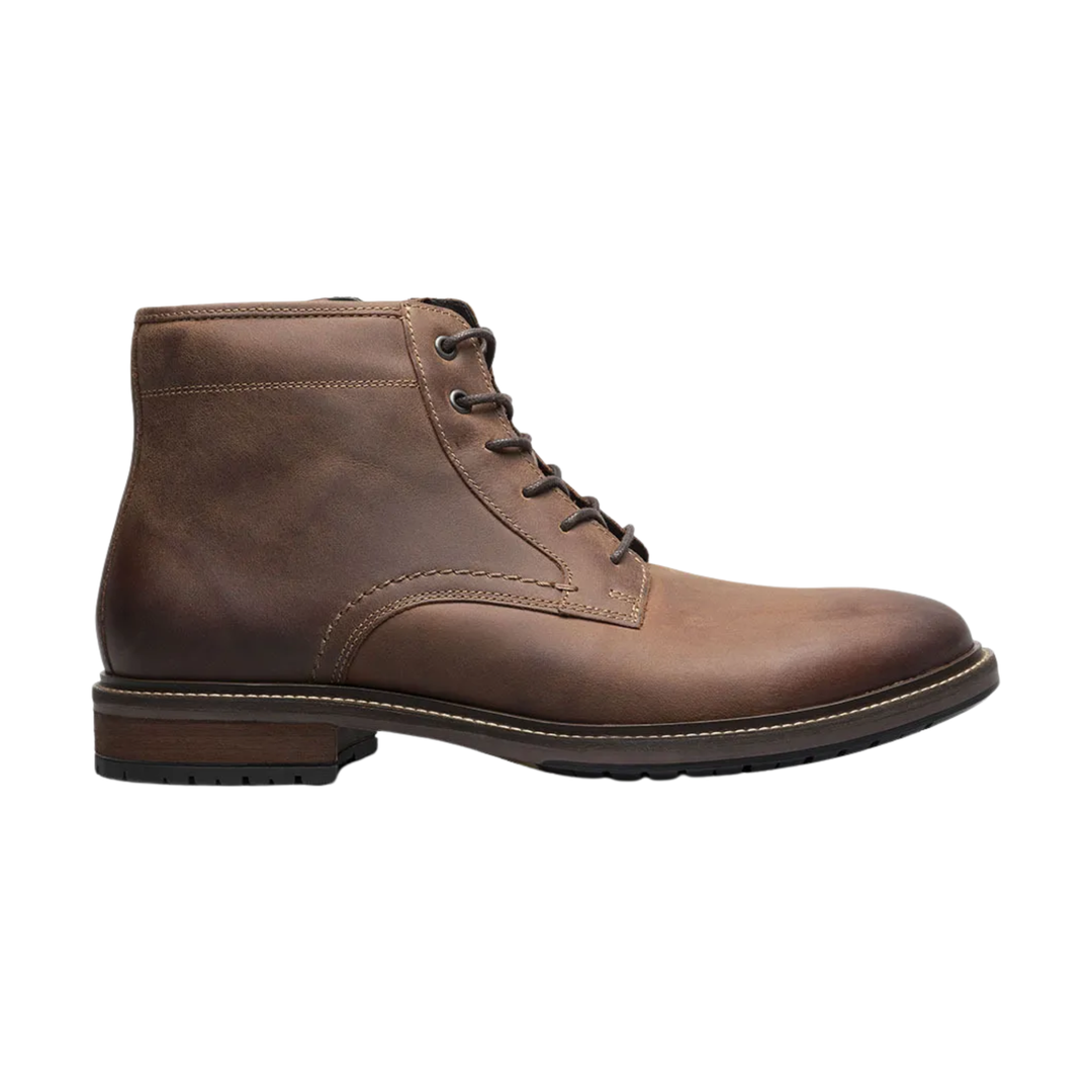 Brown leather boot on a white background