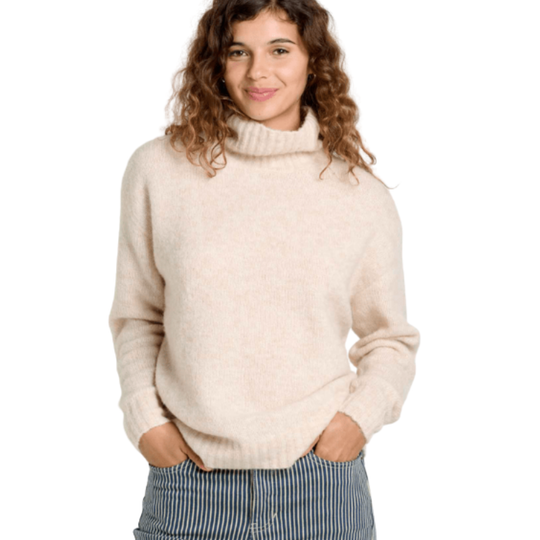 Woman wearing a beige sweater on a white background