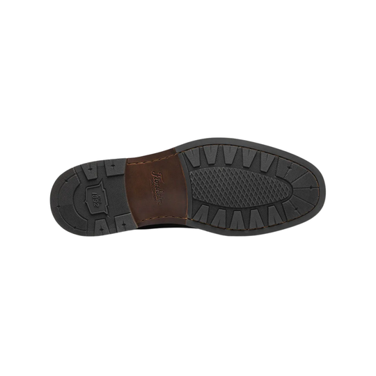 Close-up of a shoe sole with brand logo on a white background