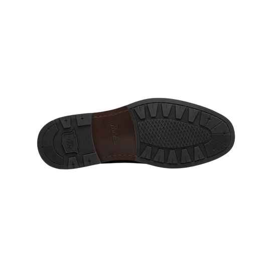 Close-up of a shoe sole with a brand logo on a white background