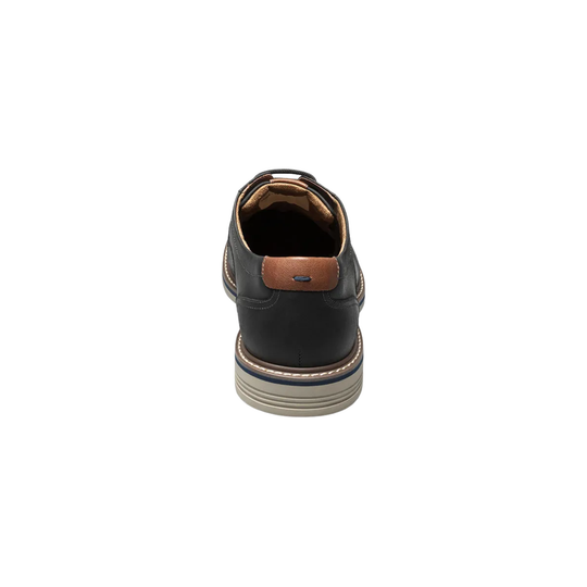 Black leather shoe with brown accents on a white background