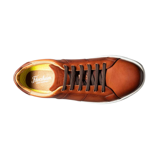 Brown leather sneaker with black laces on a white background